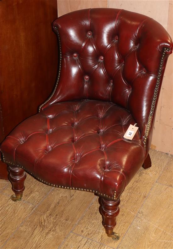 A Victorian style slipper chair upholstered in buttoned burgundy leather
